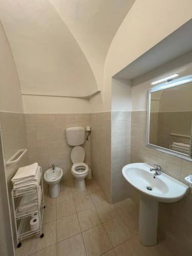 a bathroom with a sink and a toilet and a mirror at B&B La Casetta in Villa Santa Maria