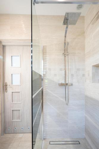 a shower with a glass door in a bathroom at JULIA in Reda
