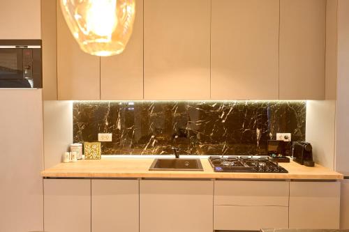 a kitchen with a sink and a counter top at EEE Apart Boutique in Constanţa