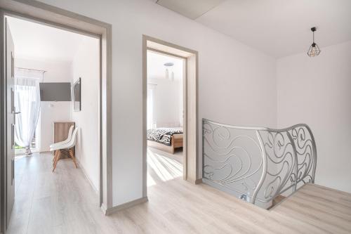 a white room with a sliding door leading to a bedroom at JULIA in Reda