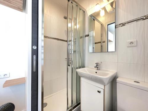 a bathroom with a sink and a shower at Appart'Village Jouy Les Metz in Jouy-en-Josas