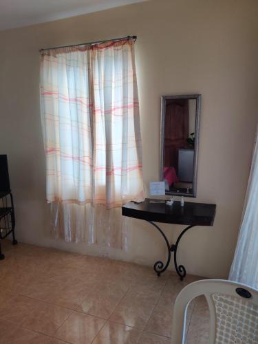 a room with a table and a mirror and a mirror at Bob Apartments in Calodyne