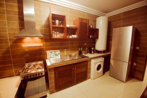 a small kitchen with a sink and a refrigerator at Residence MASSOU in Yaoundé