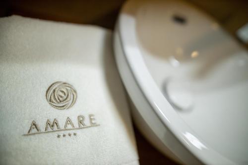 a close up of a white toilet with aarma logo on it at Amare Luxury Apartments in Budva