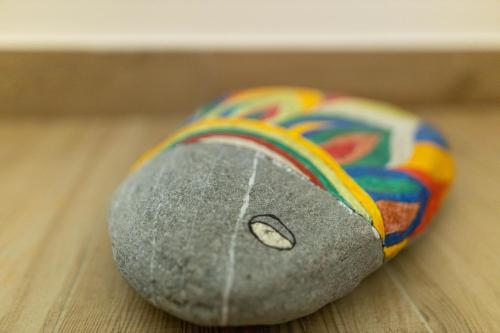 a rock with a rainbow on it sitting on a table at Amare Luxury Apartments in Budva