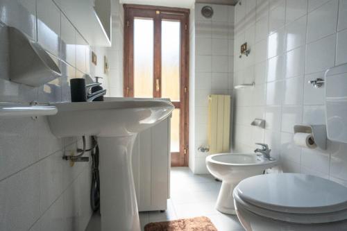 ein weißes Bad mit einem Waschbecken und einem WC in der Unterkunft casa dolce casa in Aosta