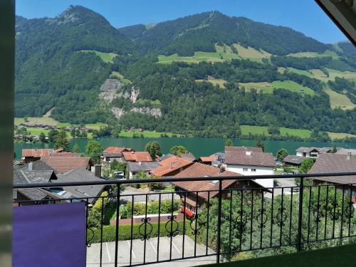a view from a balcony of a town and a lake at Elliotts Bed & Bar in Lungern