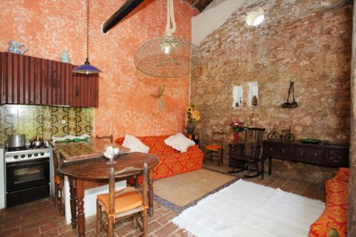 a living room with a couch and a table at Casa Grande Portugal in Burgau
