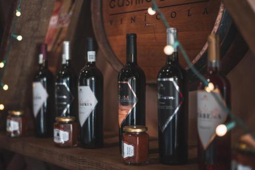 a bunch of bottles of wine sitting on a shelf at Hotel Castillo Ferrer in Valle de Guadalupe