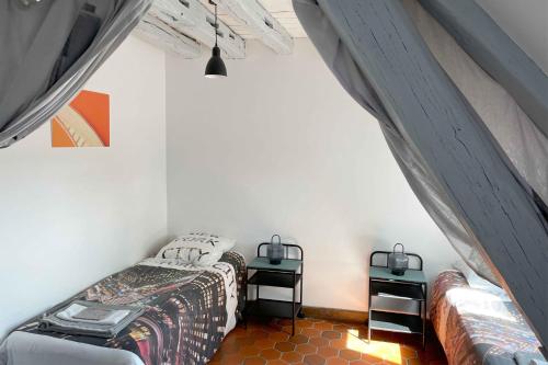 a bedroom with a bed and two night stands at Architecte Les 3 arches de Dormelles in Dormelles