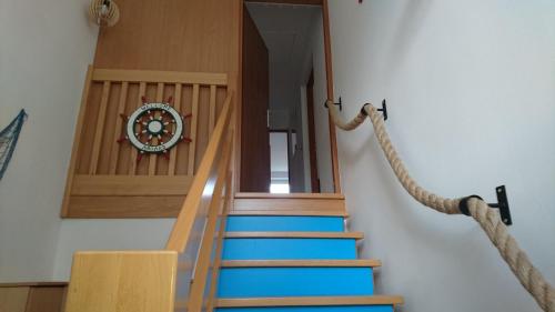 a set of stairs with a clock on the wall at Barwy Morza in Kopalino