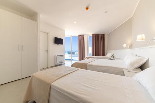 Un ou plusieurs lits dans un hébergement de l'établissement Smart Hotel Ugento