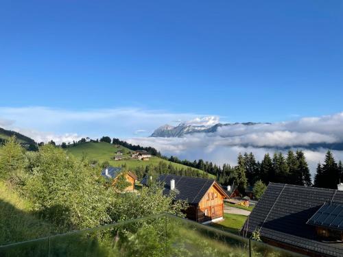 a view of a village with a snow covered mountain at Exclusive Alpenlodge ski in ski out Galsterberg in Pruggern