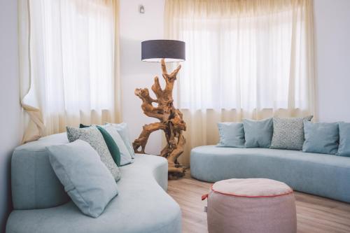 a living room with two blue couches and a lamp at Taormina Palace Hotel in Taormina