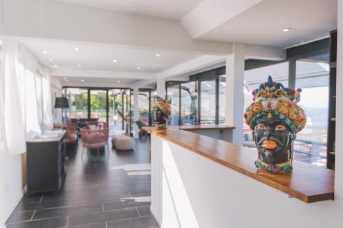 a lobby with a counter with a statue of a head at Taormina Palace Hotel in Taormina