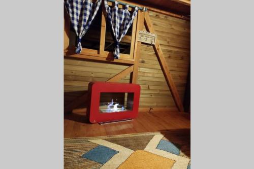 a room with a red tv in front of a stairs at La Casa En El Bosque in El Retiro