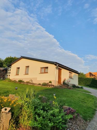 a house with a garden in front of it at Ferienhaus am Malerweg in Königstein an der Elbe
