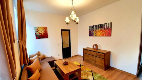 a living room with a couch and a table at Zur Krone Aparthotel in Widdershausen