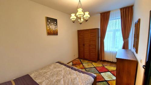a bedroom with a bed and a chandelier at Zur Krone Aparthotel in Widdershausen