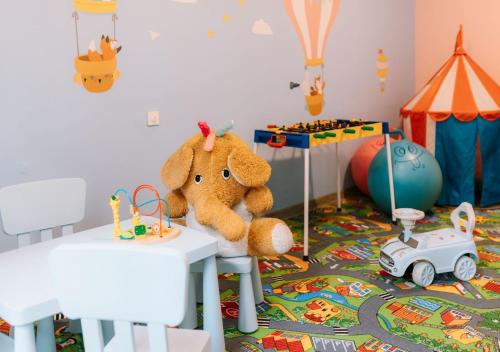 a stuffed teddy bear sitting on a table in a room at Ośrodek Szkoleniowo Wypoczynkowy ROŻNÓW in Rożnów