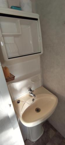 a bathroom with a white toilet and a sink at LAWENDOVO in Nowinka
