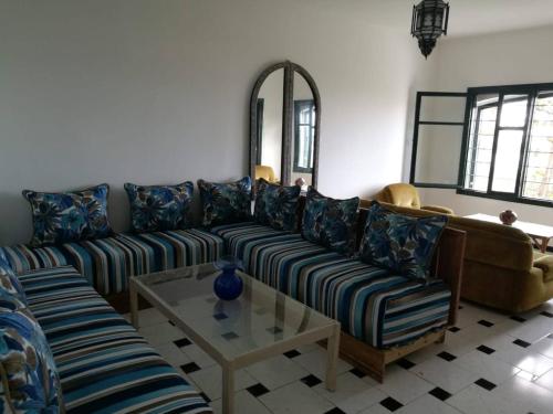 a living room with a couch and a table at Maison Etoile De Mer 2 in Skhirat