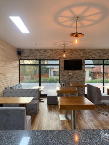 a living room with couches and tables and a tv at Apartmani Imamovic in Dubrave Gornje