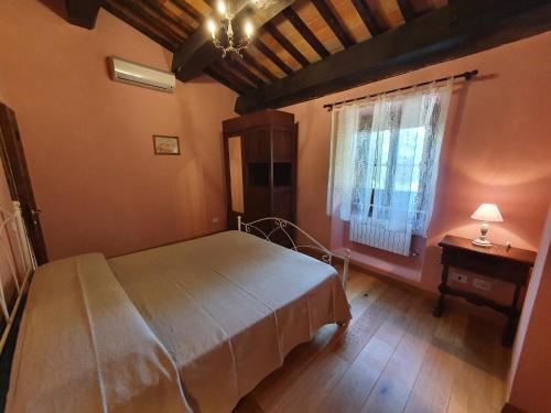 a bedroom with a large bed and a window at Casa Giogo in Arezzo