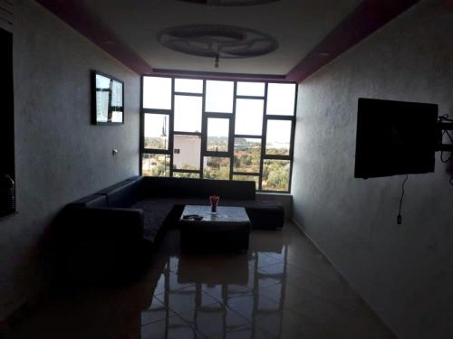 Appartements proches de la mer Boukidan Al Hoceima في الحسيمة: غرفة معيشة مع أريكة وطاولة