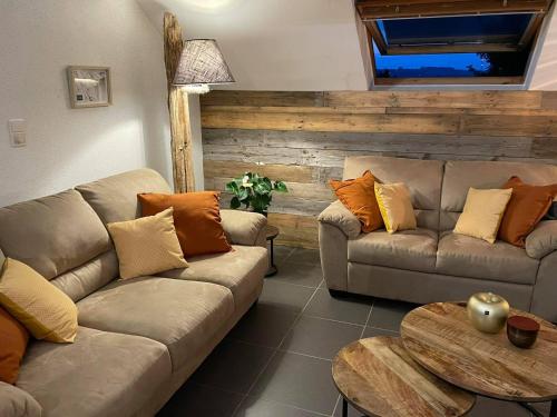 a living room with two couches and a table at Escape at Durbuy in Durbuy