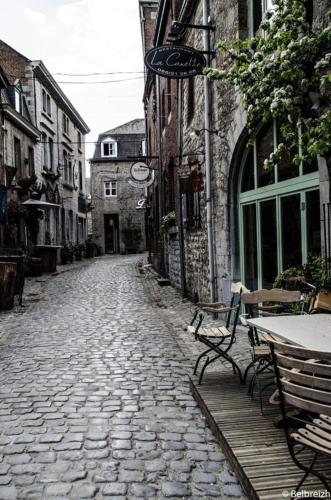 a cobblestone street with tables and chairs on a cobblestone street at Escape at Durbuy in Durbuy