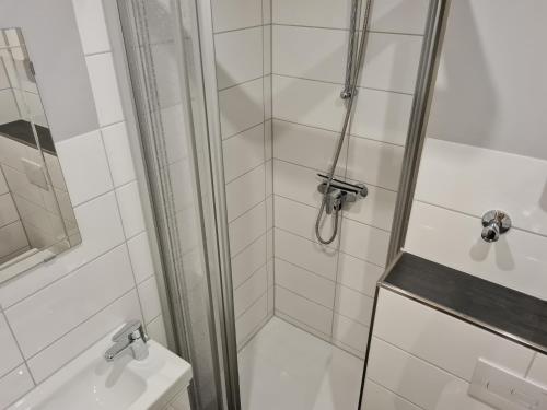 a bathroom with a shower and a toilet and a sink at Bergstation Altenau in Altenau