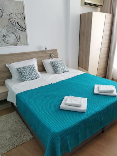 a bedroom with a large bed with two towels on it at Silver A 27 in Byala