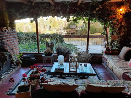 a living room with a fireplace and a table at Le Bouquet Apart Hotel in San Carlos de Bariloche