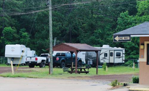 a truck parked next to a trailer and a tent at Evergreen Inn and R.V. in Winnfield
