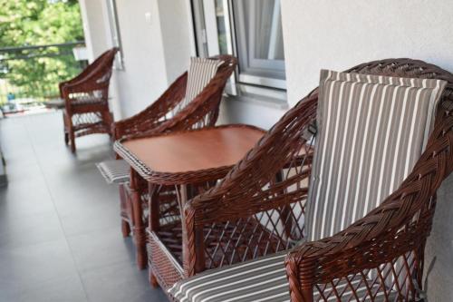 two chairs and a table on a balcony at Villa Bella in Golubac