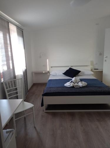 a bedroom with a bed with shoes on it at Bouganville da Giò in Scalea