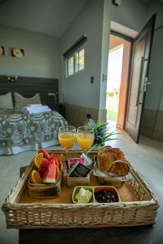 a tray of breakfast foods and drinks on a table at Cabañas y Habitaciones Terra Nostra Complejo in General Alvear