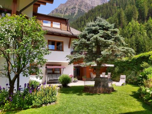a house in the mountains with a garden at Haus Gfall in Kaunertal
