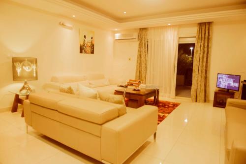 a living room with a couch and a table at Residence MASSOU in Yaoundé