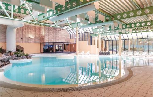 a large swimming pool in a building at Escape at Durbuy in Durbuy