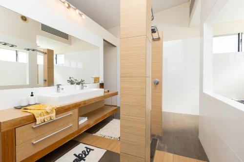 a bathroom with a sink and a mirror at Koolinda by the Bay, Broome WA in Broome