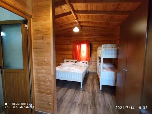 a room with two beds and a bunk bed at Kompleksi Turistik EDIR in Orikum