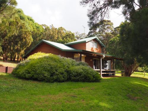 a house with a green roof on a green yard at Augusta Sheoak Chalets in Augusta