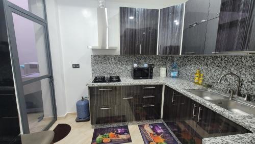 a kitchen with a sink and a counter top at ZR Comfort in Fès