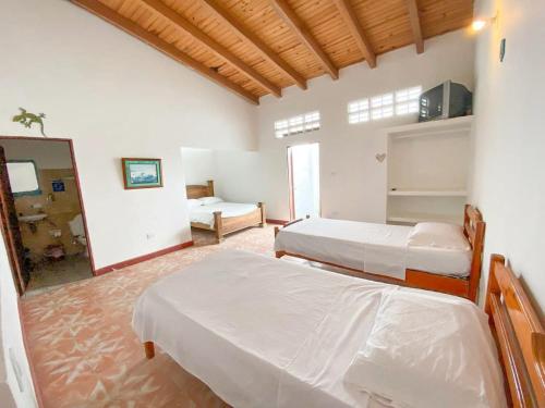 A bed or beds in a room at Hotel Refugio J.G