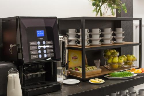 a microwave oven sitting on a kitchen counter with food at Hotel Alexander in Kraków