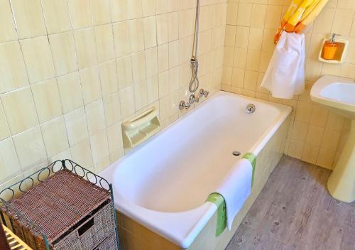 La salle de bains est pourvue d'une baignoire blanche et d'un lavabo. dans l'établissement Casa La Rosa - mare e pineta - 2 bici incluse, à Viareggio
