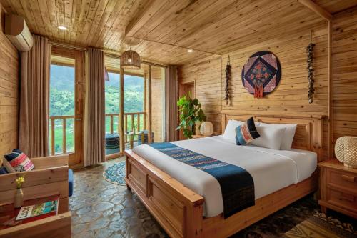 1 dormitorio con 1 cama en una cabaña de madera en Laxsik Ecolodge en Sa Pa