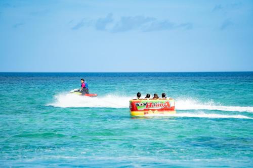 a group of people riding on a jet ski in the water at Hotel Monterey Okinawa Spa & Resort in Onna